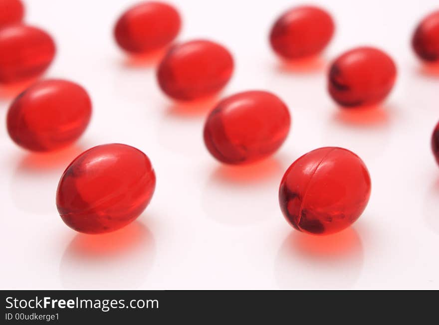 Red capsules on white background