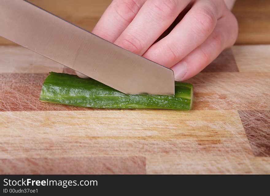 Cutting the cucumber with a kitchen knife