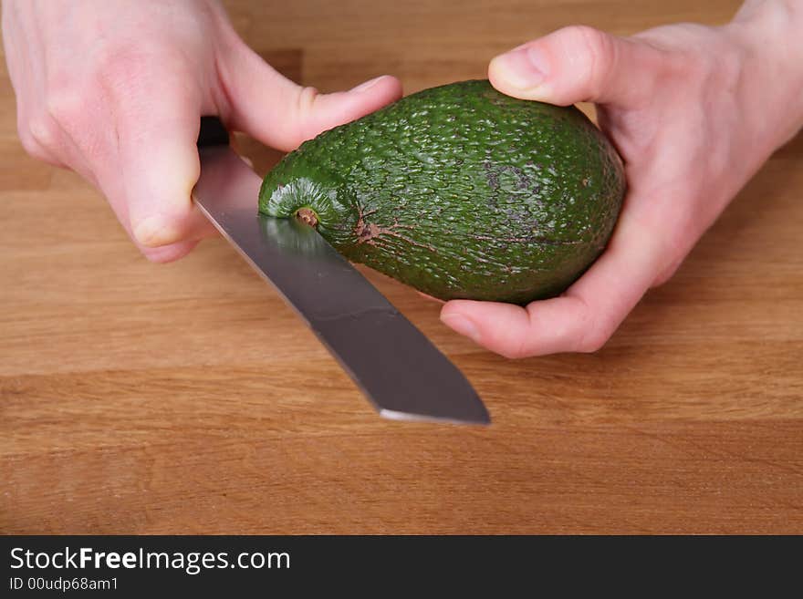 Avocado while being cut with a knife