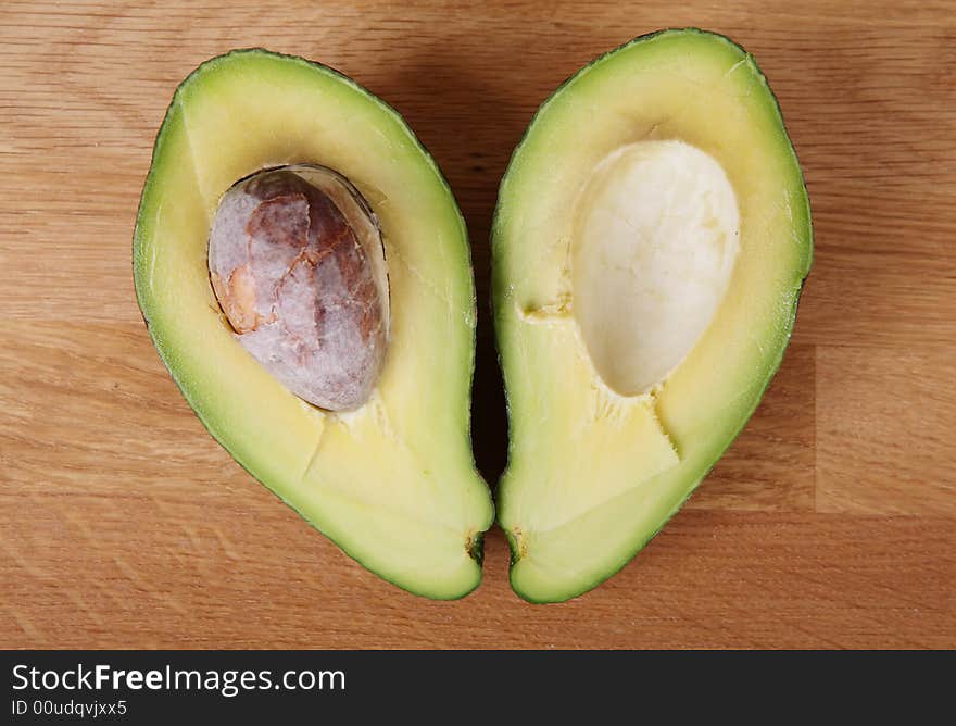 Two halves of avocado making heart shape. Focus point on fruit (not the stone). Two halves of avocado making heart shape. Focus point on fruit (not the stone).