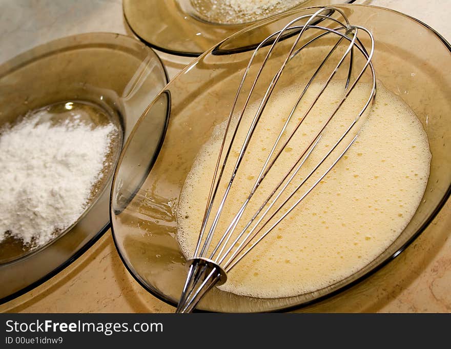 Silver whisk with mixed eggs for baking