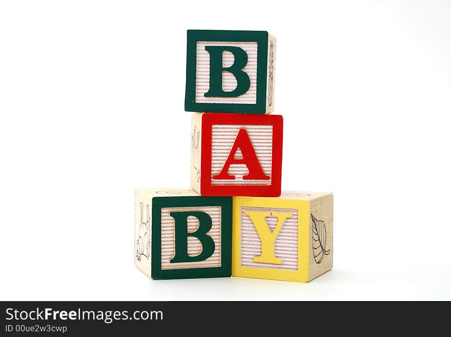 Word baby formed by alphabet wood blocks on a white surface