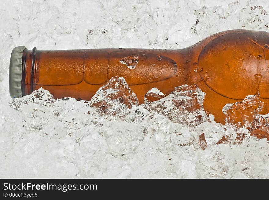 Close-up of the neck of an ice cold beer, resting in crushed ice. Close-up of the neck of an ice cold beer, resting in crushed ice.