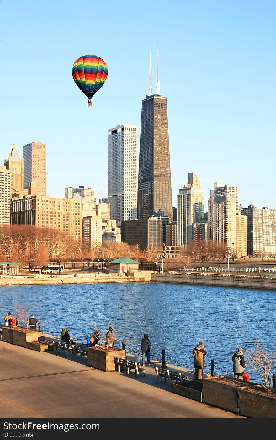 Hot air balloon flies above high-rise buildings in downtown Chicago. Hot air balloon flies above high-rise buildings in downtown Chicago.