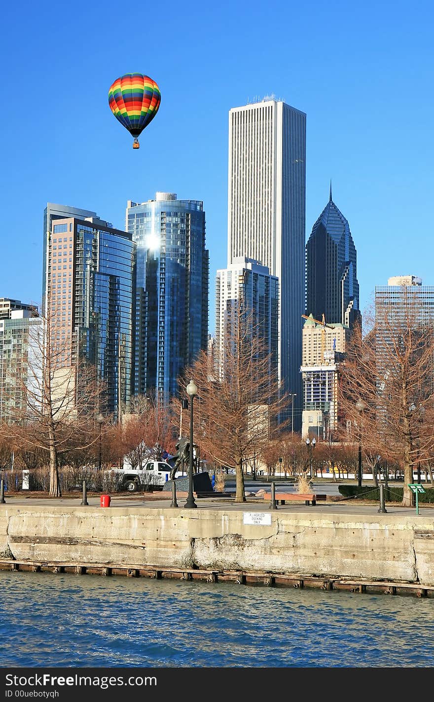 Hot air balloon flies above high-rise buildings in downtown Chicago. Hot air balloon flies above high-rise buildings in downtown Chicago.