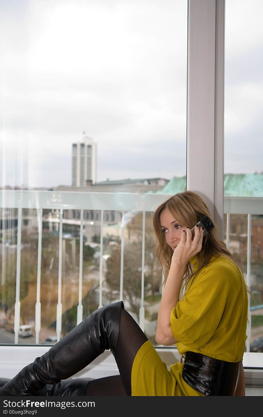 Woman talks on the phone (focus on the cup of coffee)