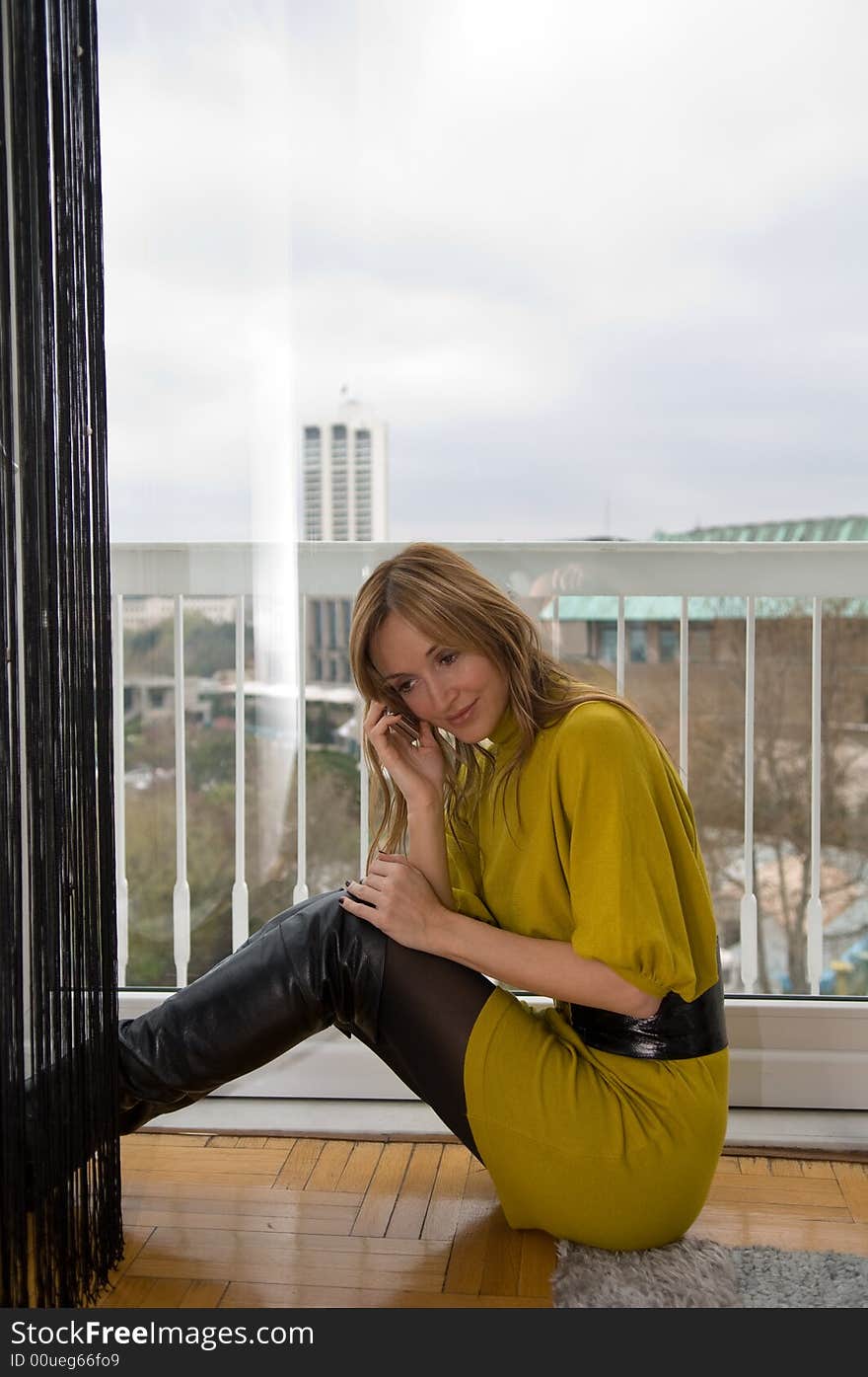 Woman talks on the phone (focus on the cup of coffee)