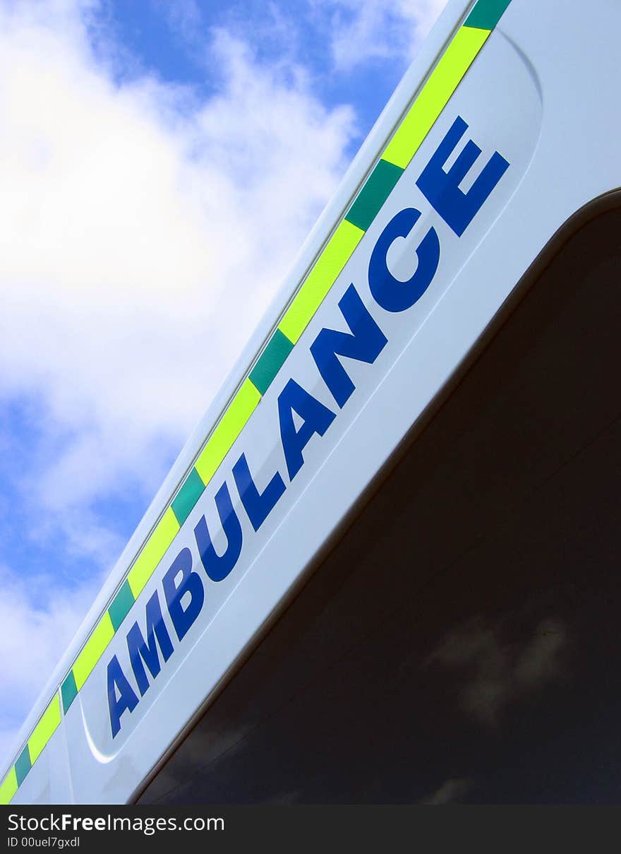 Close-up of ambulance sign against cloudy sky. Close-up of ambulance sign against cloudy sky