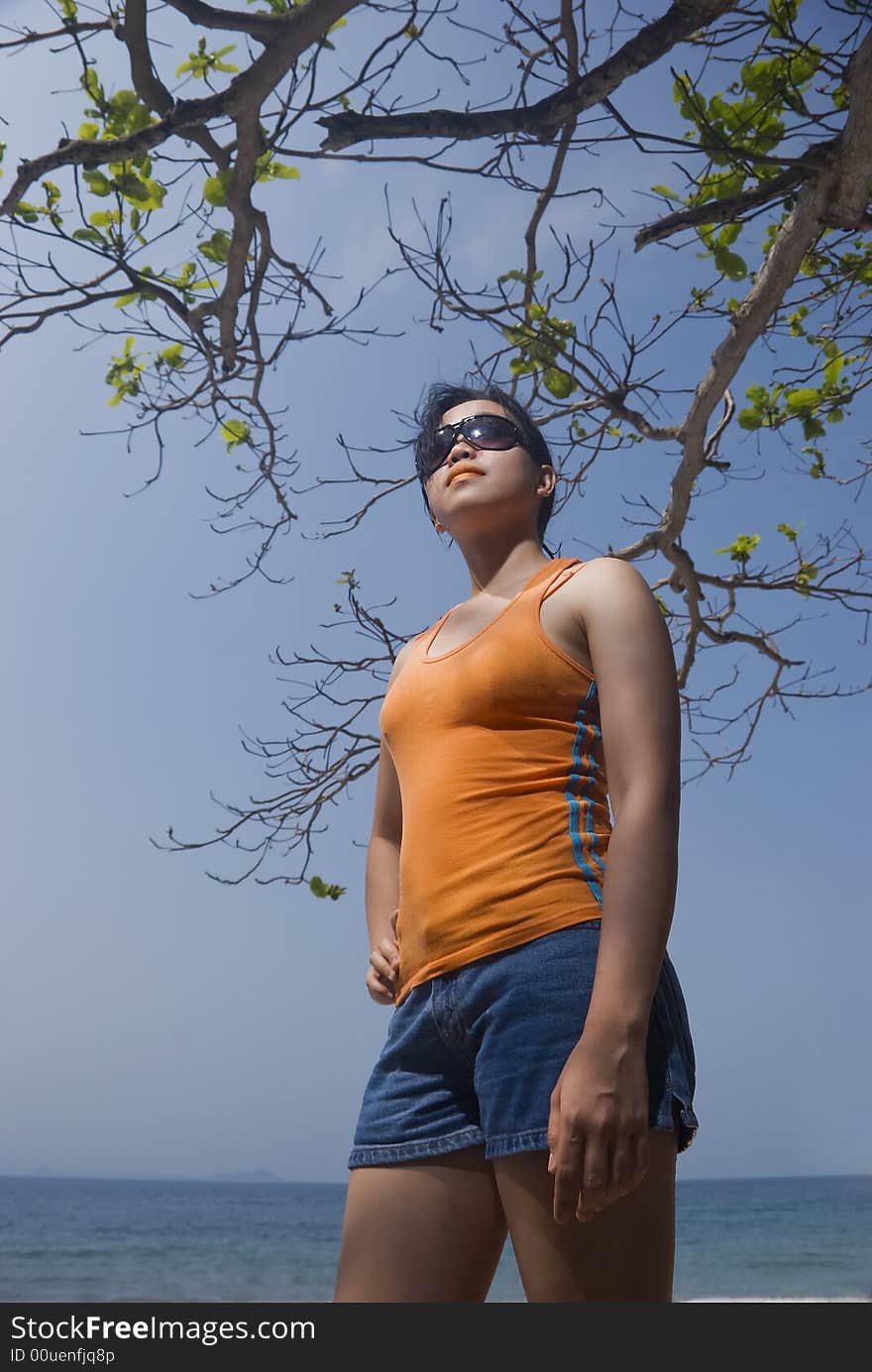 Asian woman standing on beach