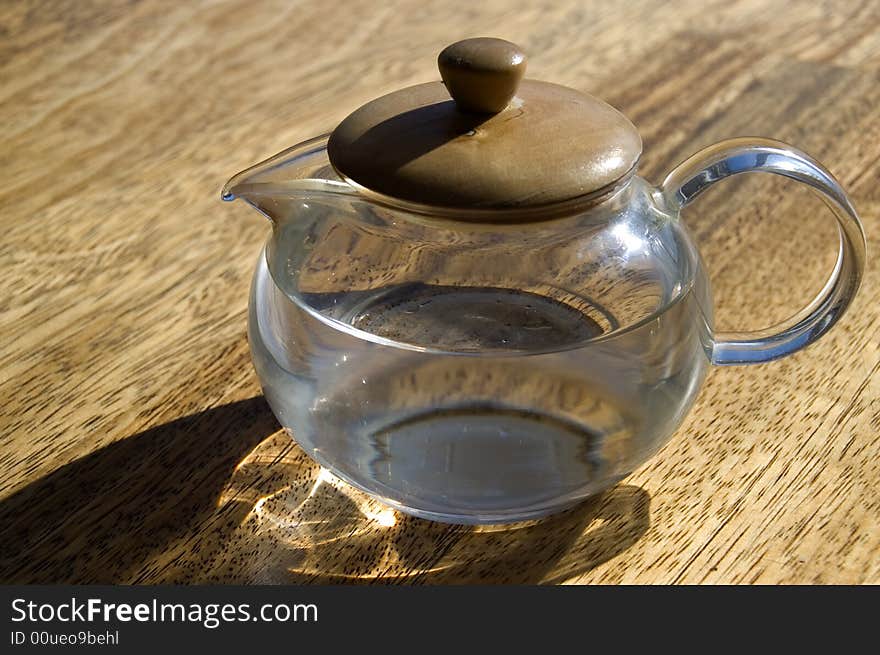 Transparent cup with water on a wooden floor. Transparent cup with water on a wooden floor.