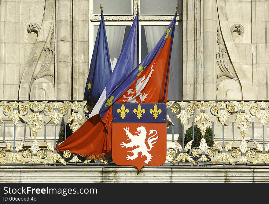 France; Lyon or Lyons: view of the facade of the town hall with his statues and carved halls ; the most popluar is the statue of the king Henri 4th. the construction is from the 16th century; in the image the french and the city flags together with the city coat arms, the lion, at the window of the city hall. France; Lyon or Lyons: view of the facade of the town hall with his statues and carved halls ; the most popluar is the statue of the king Henri 4th. the construction is from the 16th century; in the image the french and the city flags together with the city coat arms, the lion, at the window of the city hall