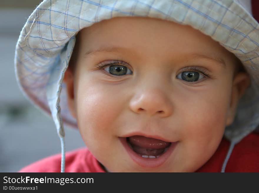 Smiling boy with blue hat on the head