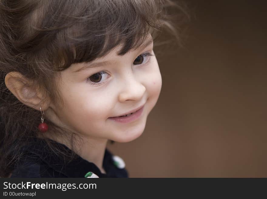 Young girl from profile with red earrings