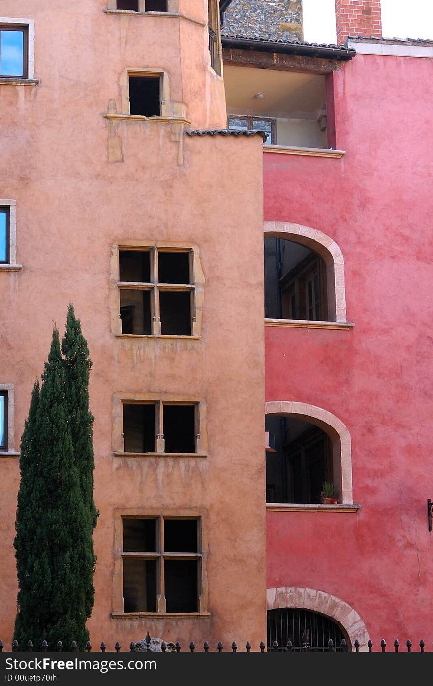 France; Lyon; Lyons; old city; medieval architecture; typical building from the Vieux Lyon, the old city; the pink and ochre colors and the architectural arches shows the strong italian heritage. France; Lyon; Lyons; old city; medieval architecture; typical building from the Vieux Lyon, the old city; the pink and ochre colors and the architectural arches shows the strong italian heritage