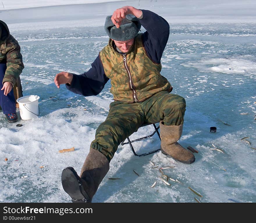 A winter fishing on river. People is fishing the smelt. Russian Far East, Primorye, Kievka river. A winter fishing on river. People is fishing the smelt. Russian Far East, Primorye, Kievka river.