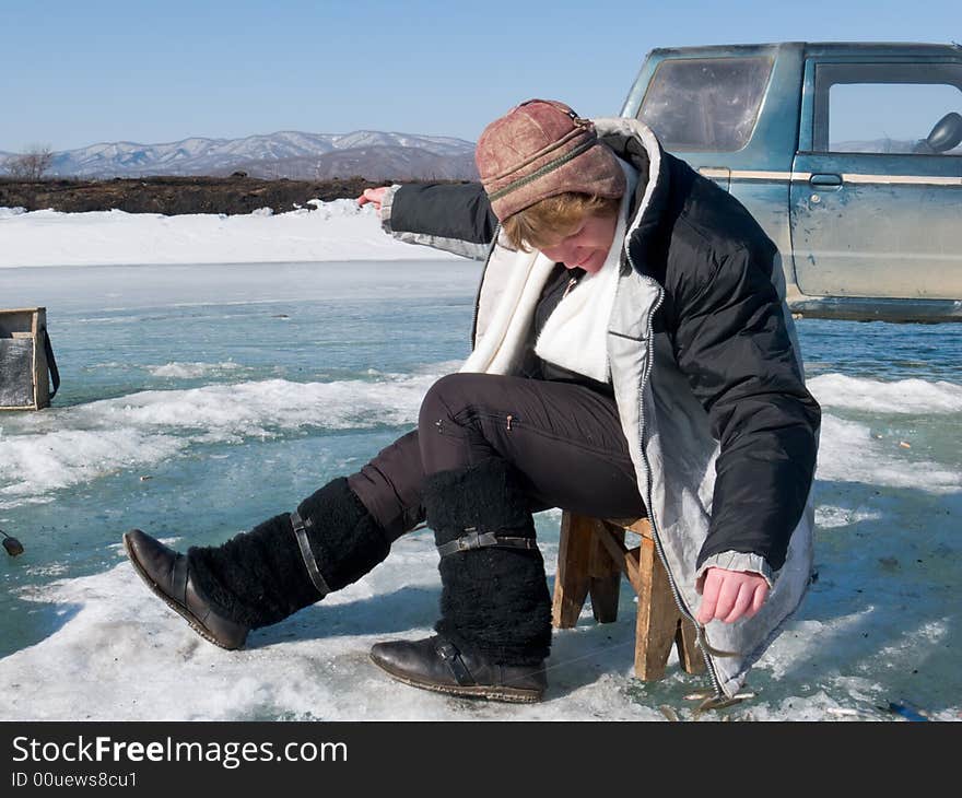 A winter fishing on river. People is fishing the smelt. Russian Far East, Primorye, Kievka river.