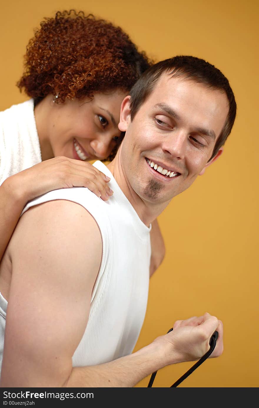 Young attractive couple having fun while working out at the gym. Young attractive couple having fun while working out at the gym