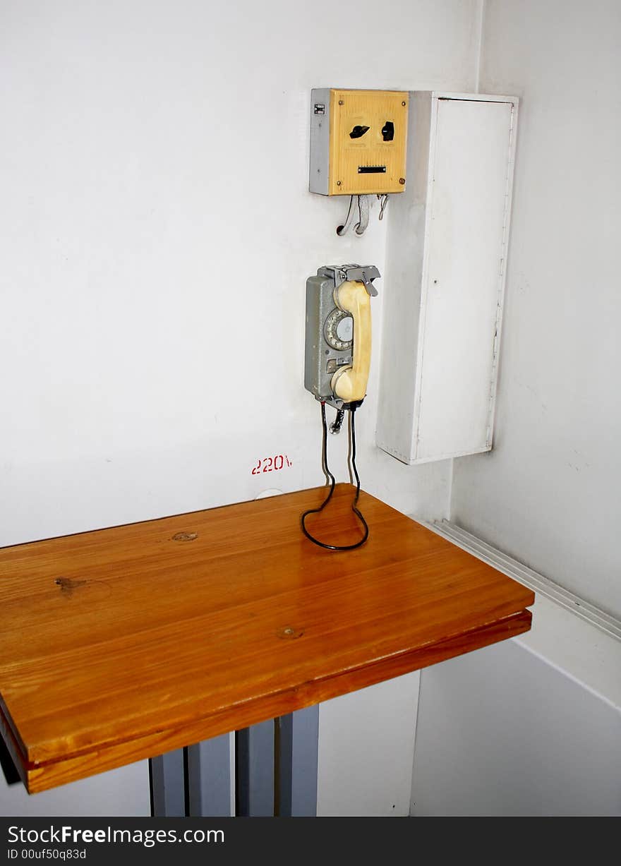 Old retro interior with a metal telephone on the wall. Old retro interior with a metal telephone on the wall