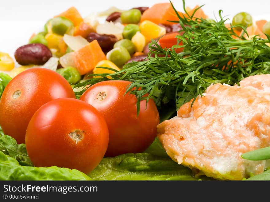 Stake from a salmon with vegetables on a plate close-up.