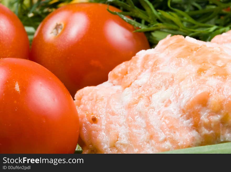 Stake from a salmon with vegetables on a plate close-up.