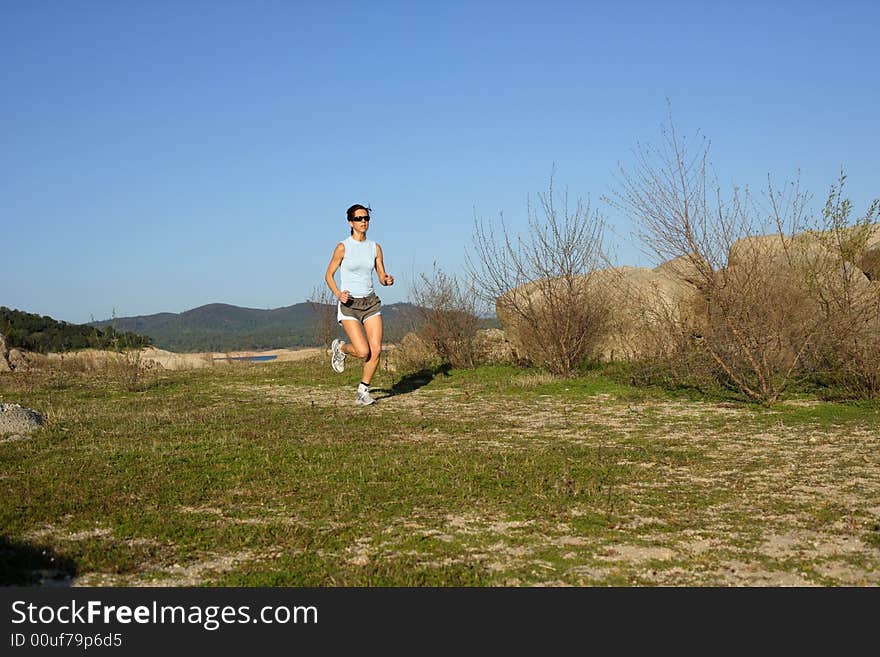 A woman running down a path at the beach