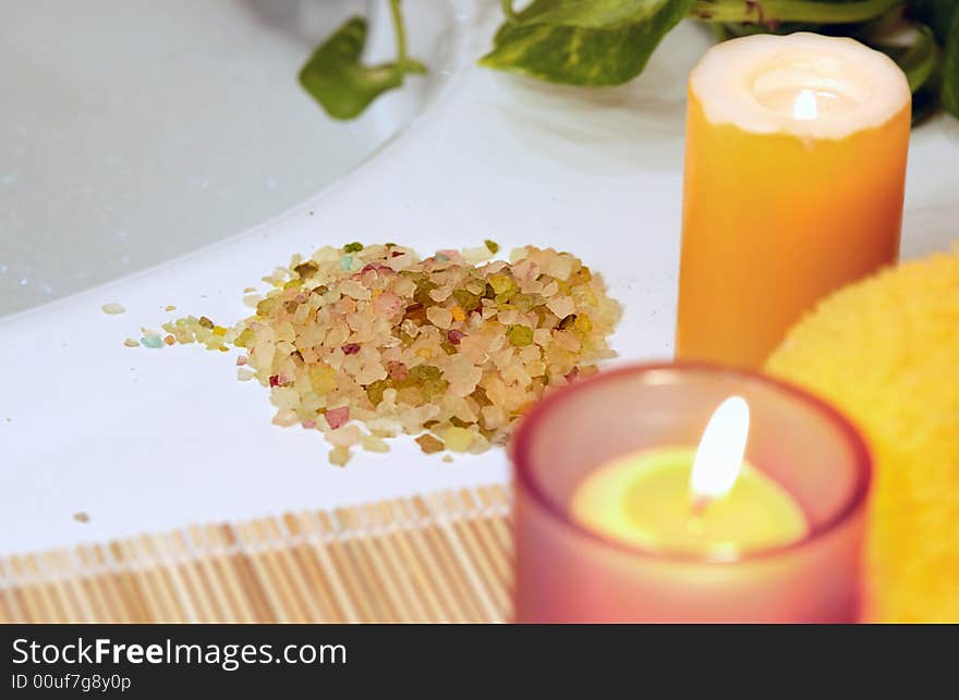 lighting yellow candles, towel, salt for home spa