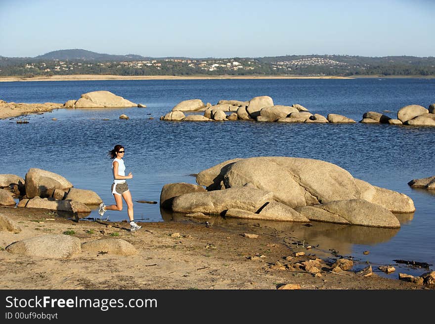 A woman running down a path at the beach