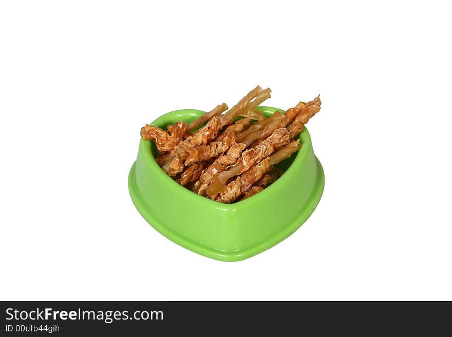 A green bowl full of dry food for dog. A green bowl full of dry food for dog