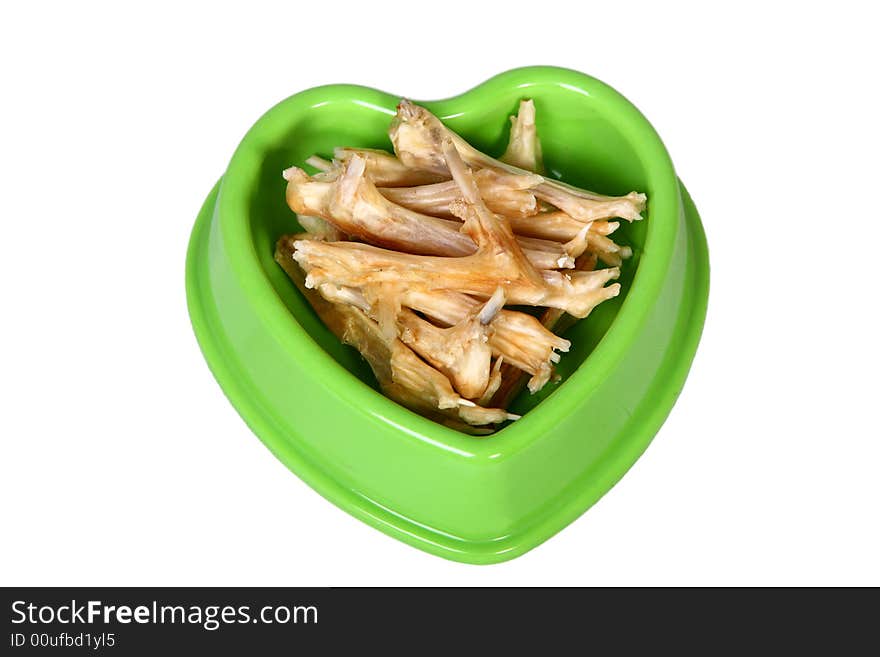 A green bowl full of dry food for dog. A green bowl full of dry food for dog