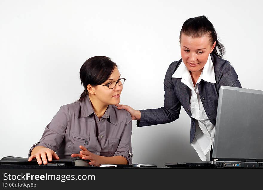 Two attractive brunette businesswomen working in office. Two attractive brunette businesswomen working in office