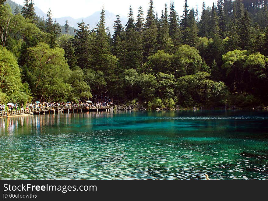 Lake in Jiuzaigou nature protection area, Sichuan province, South-West China. 

Jiuzaigou translates to: nine village valley. It is a well know area in China. About 20000 tourists per day are visiting Jiuzaigou.