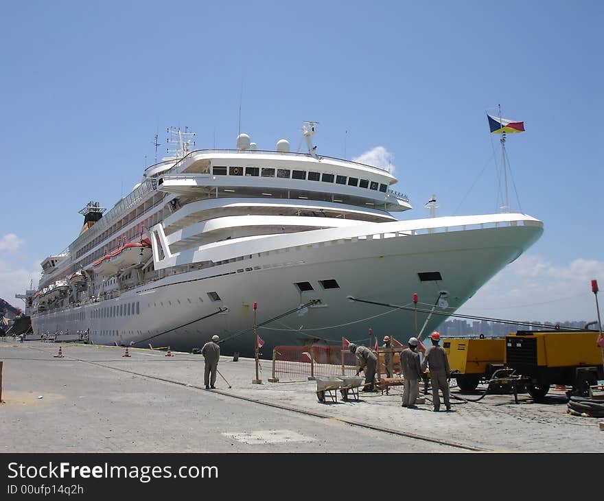 A white cruise ship at dock.