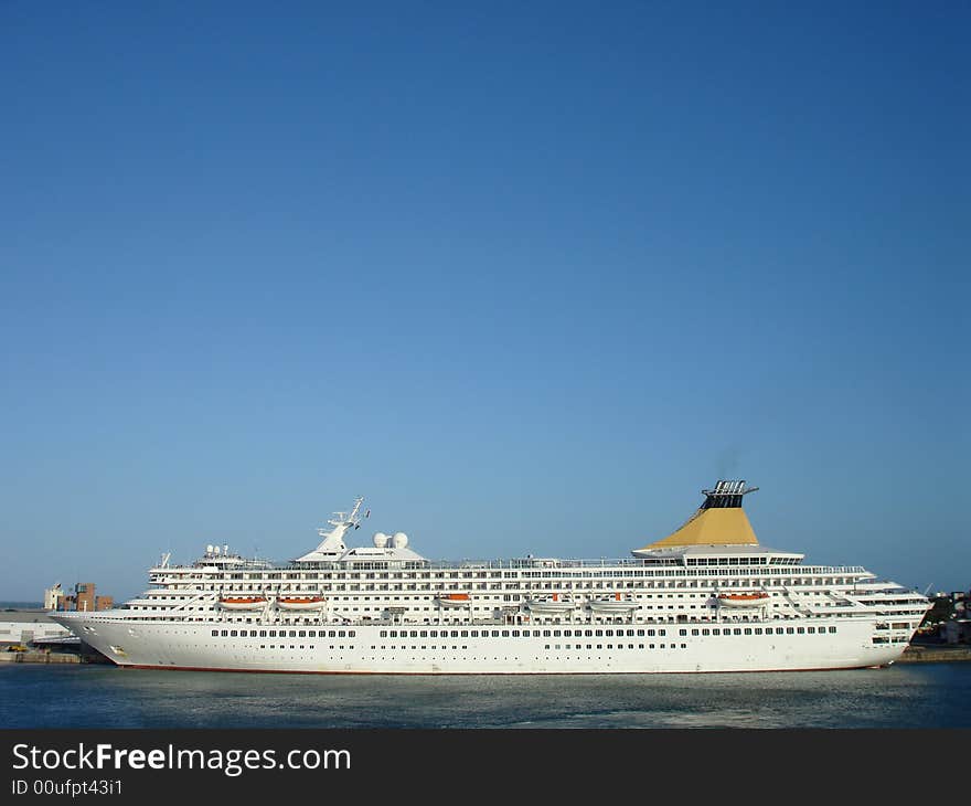 A white cruise ship at dock.