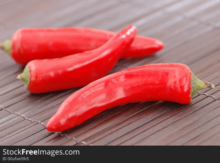 Red chillies on a place mat.