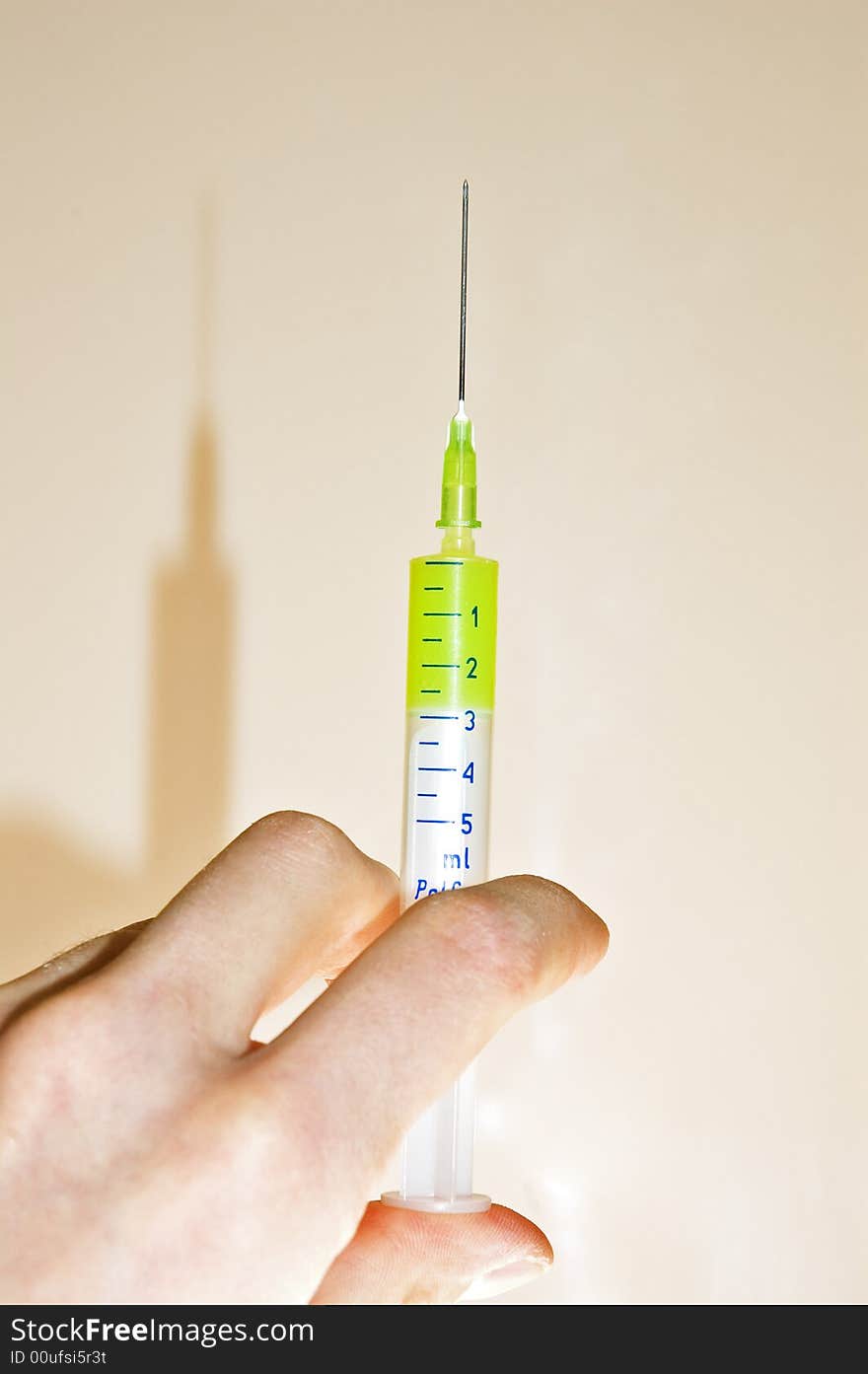 Men's hand have small syringe. Men's hand have small syringe