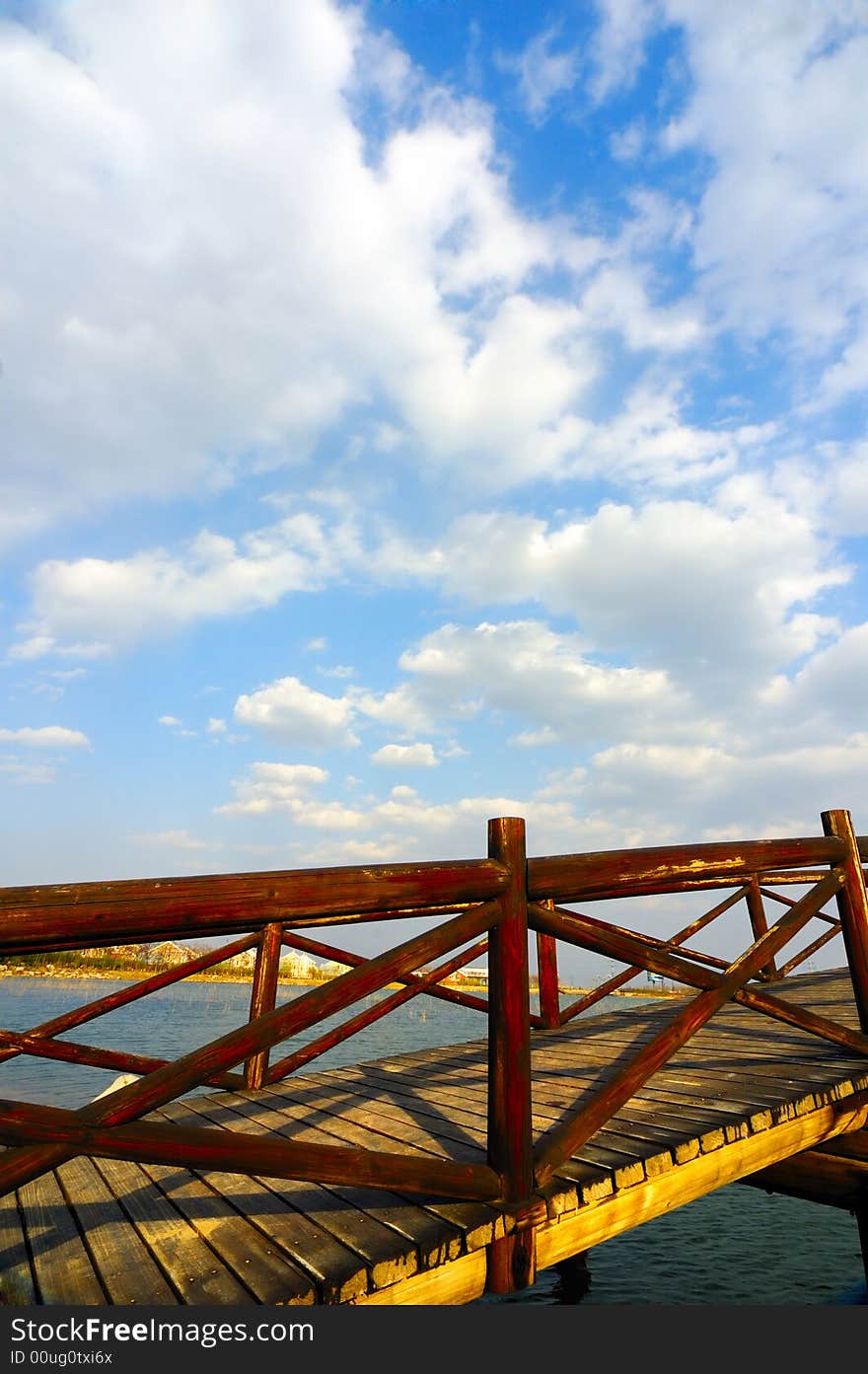 Wooden arch  bridge under the sky and clouds. Wooden arch  bridge under the sky and clouds