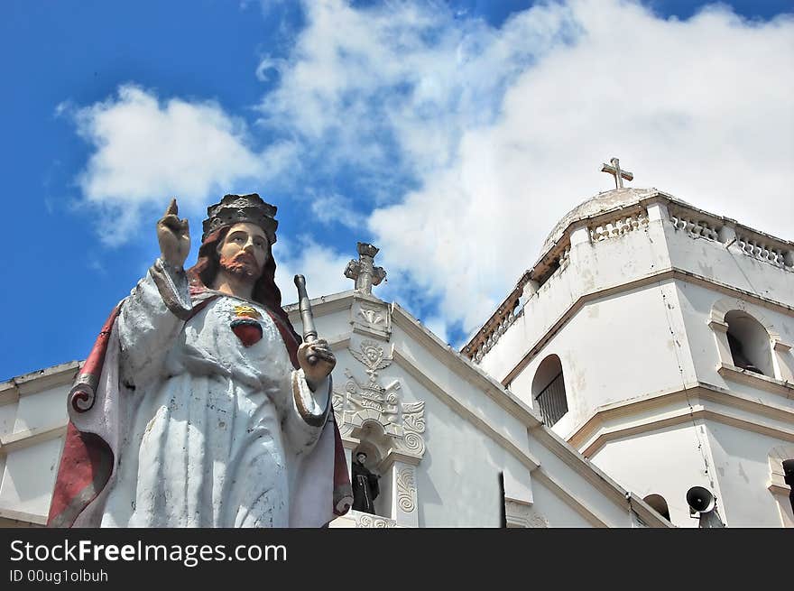 Jesus christ statue in front of a church facade. Jesus christ statue in front of a church facade