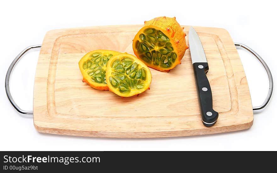 Kiwano or African horned melon sliced open over white. Also known as hedged gourd, African Horned Cucumber, English tomato.