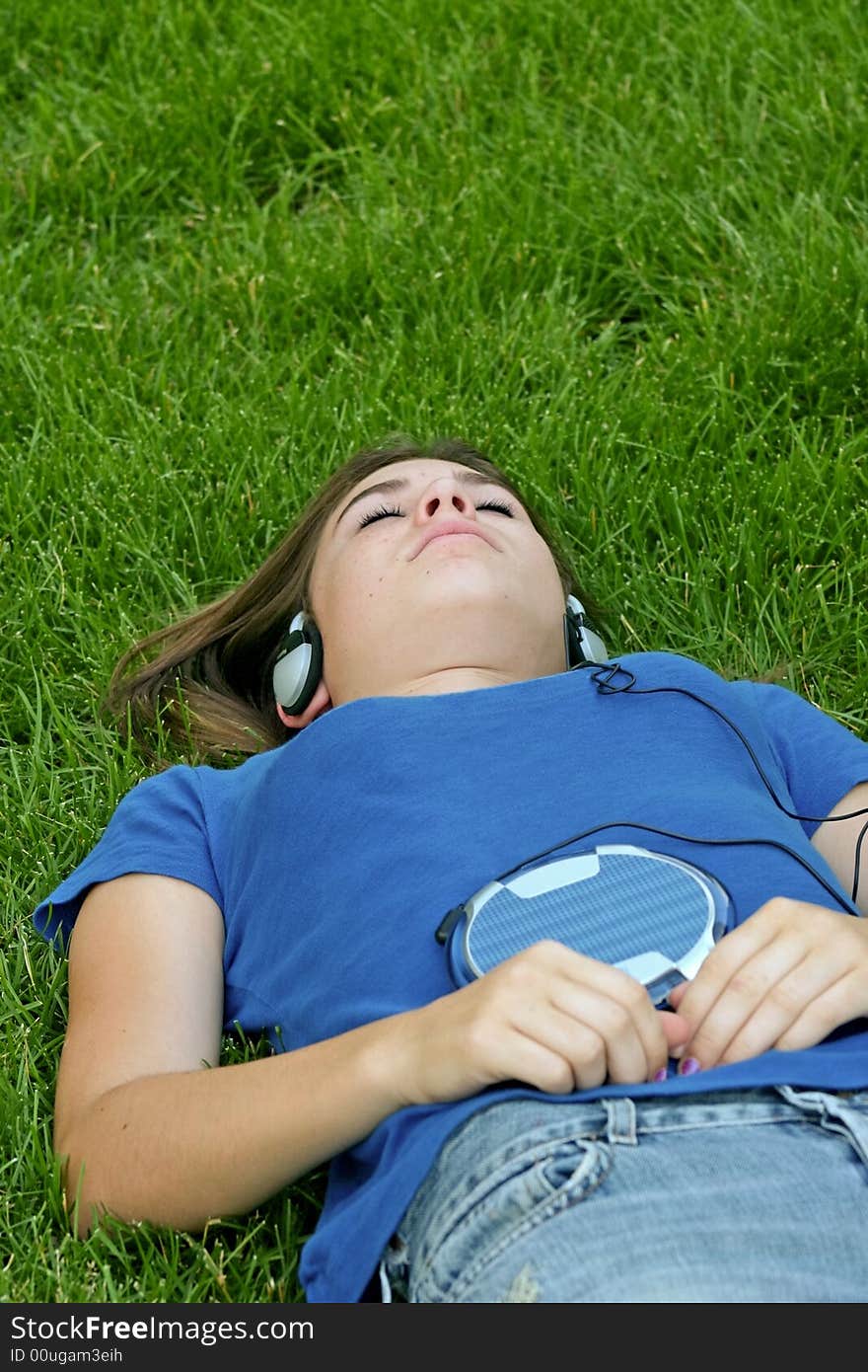 Teenager Laying in Grass Listening to Music. Teenager Laying in Grass Listening to Music