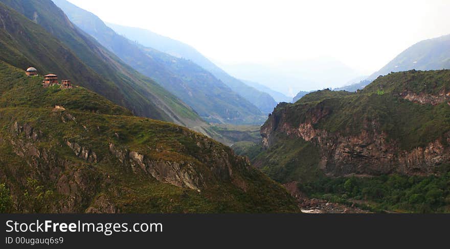 A tiny cable car daggles high above a spectacular canyon gorge near the town of Banos Ecuador. A tiny cable car daggles high above a spectacular canyon gorge near the town of Banos Ecuador