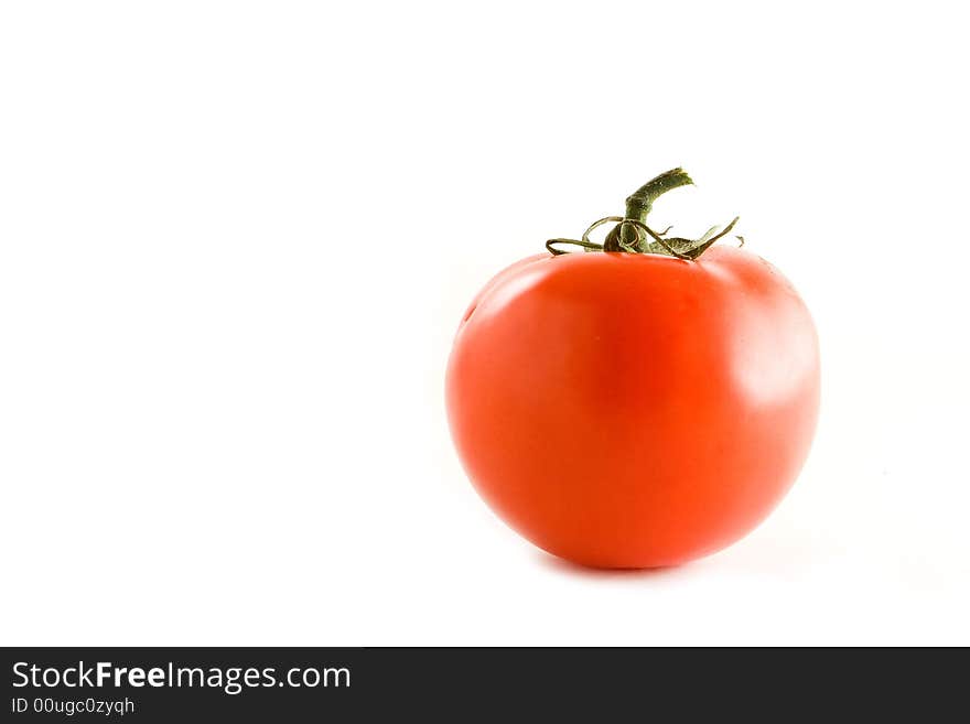 An isolated tomato over a white background.