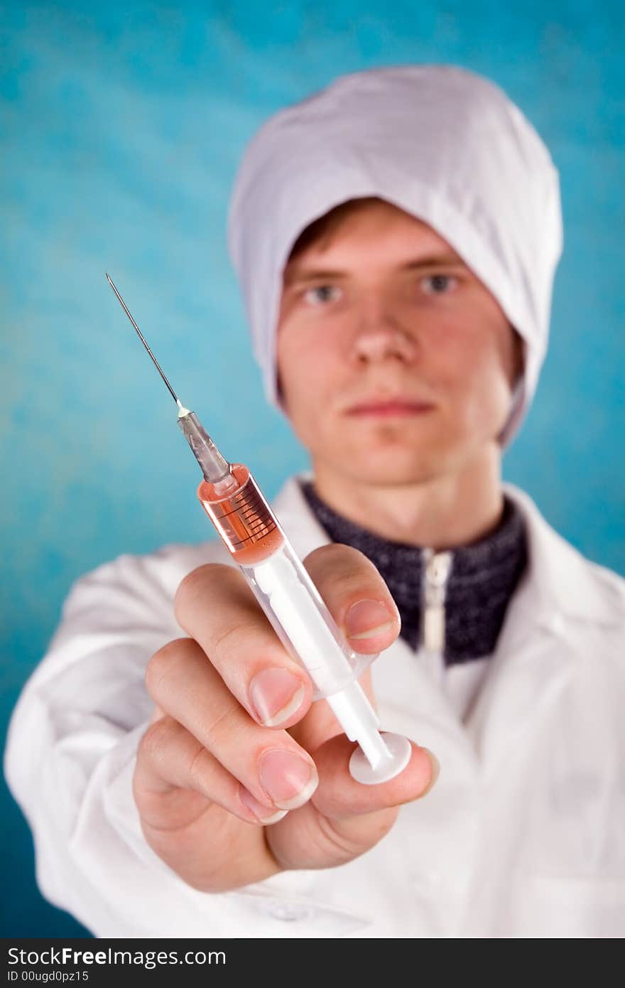 The medical worker with a syringe in a hand. The medical worker with a syringe in a hand.