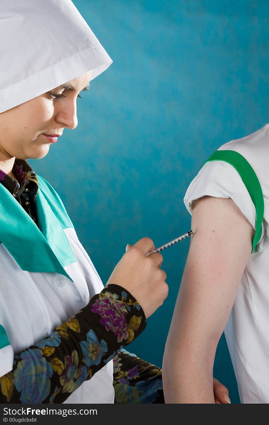 Young female doctor giving injection of insulin to a patient.