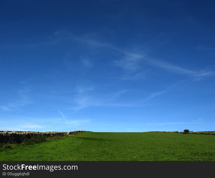 Saturated blue sky and green field