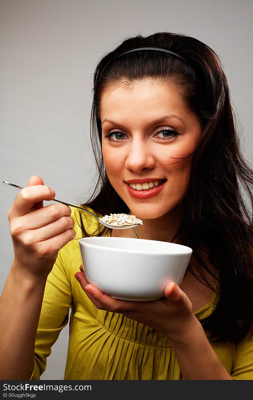 Young beautiful woman with cup of muesli. Young beautiful woman with cup of muesli