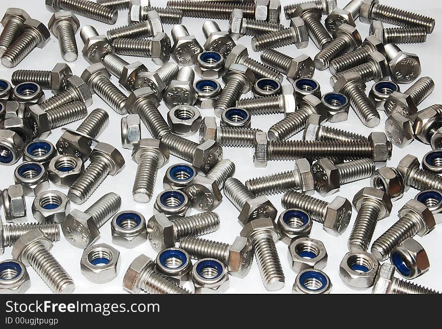 Scatterred nuts and bolts on a white background