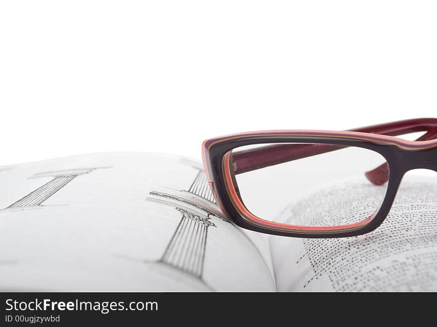 Glasses on the open book. White background. Camera Pentax k10d kit.