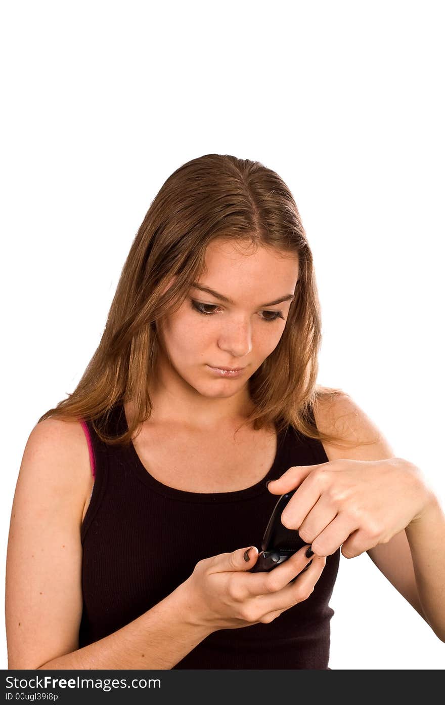 Young woman with her mobile phone flipped open looking at the screen. Young woman with her mobile phone flipped open looking at the screen