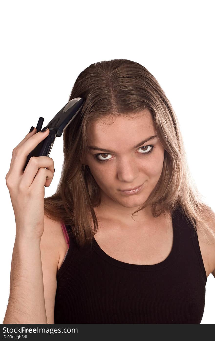 Young woman with her mobile phone flipped open held against her head. Young woman with her mobile phone flipped open held against her head