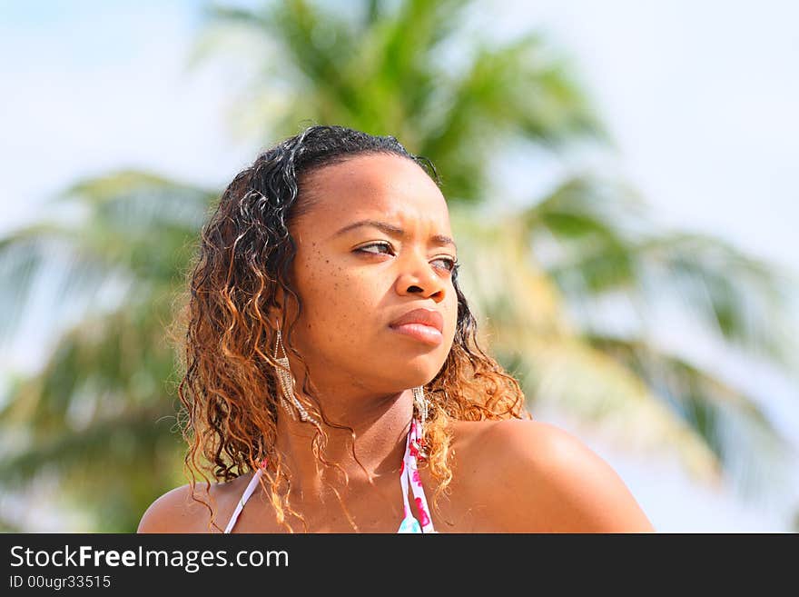 Woman outside with a blurry palm tree background